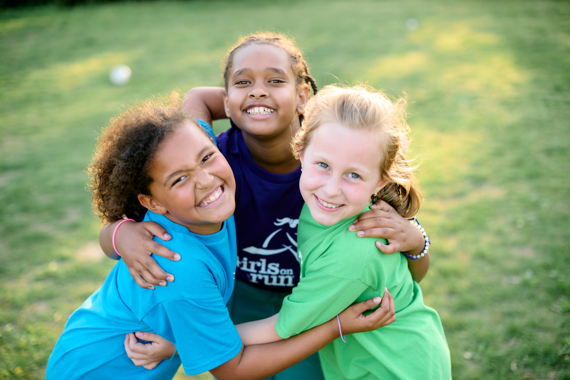 Three girls hugging